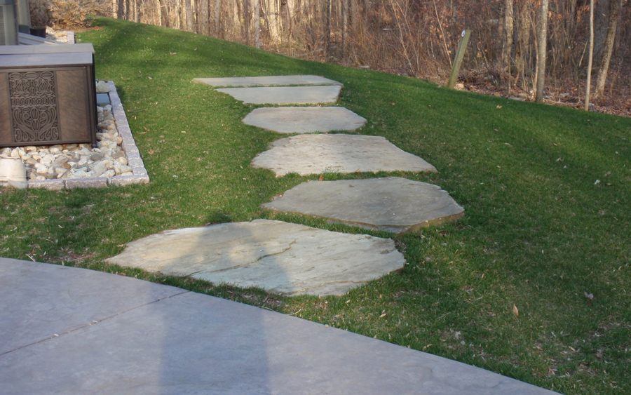 Stepping stone path integrated into a residential landscape and hardscape plan